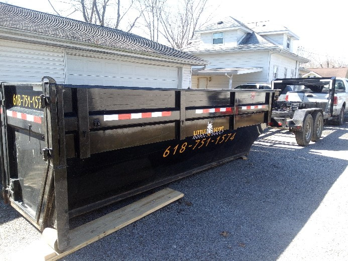 Little Egypt dumpster alongside a residential garage